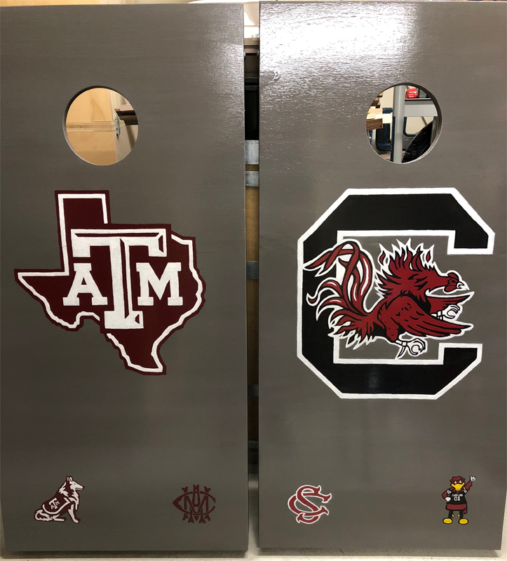 Cornhole boards with TAMU and USC logos